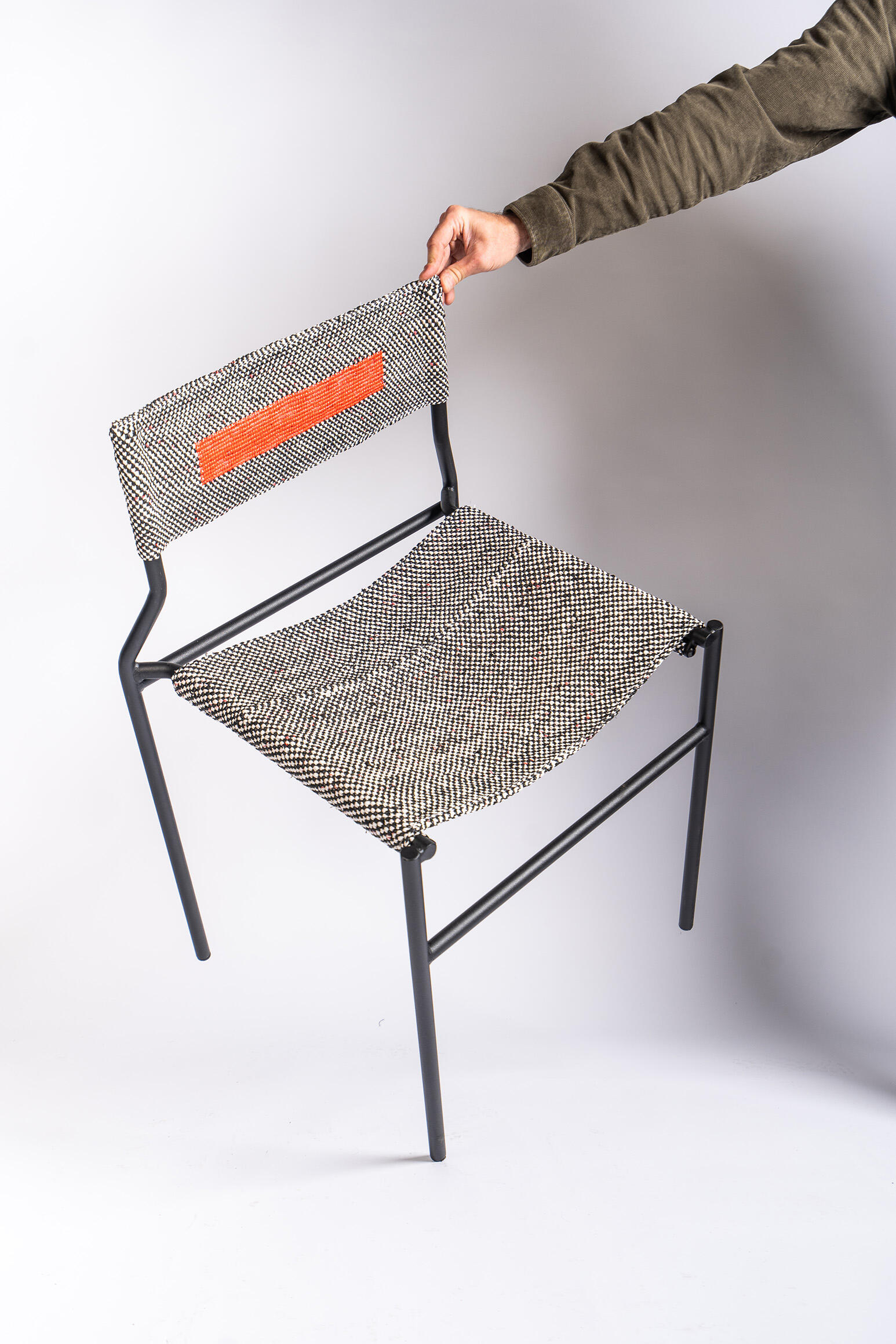 Experimental chair combining Recycled plastic bags woven textile craftsmanship with a contemporary structure