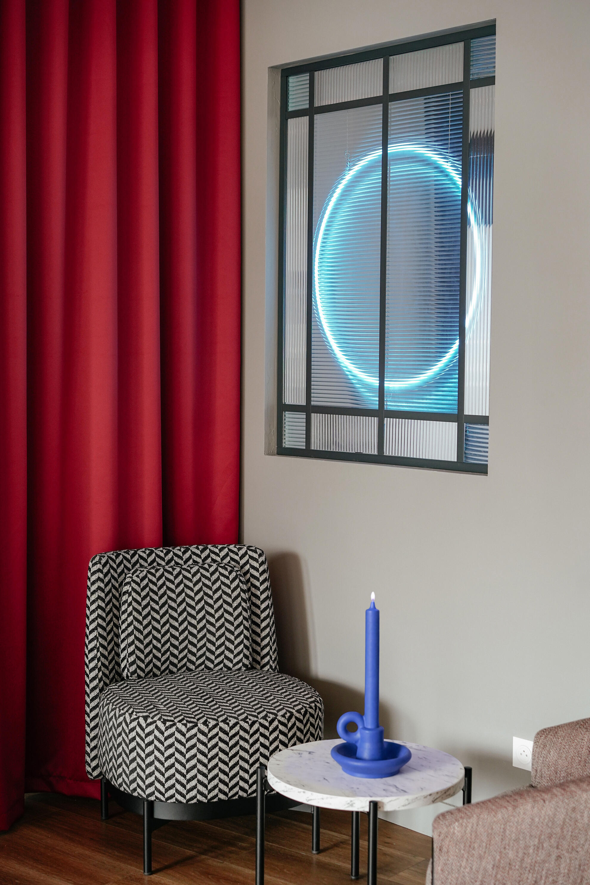 Interior design detail combining textiles, natural light and architectural composition.