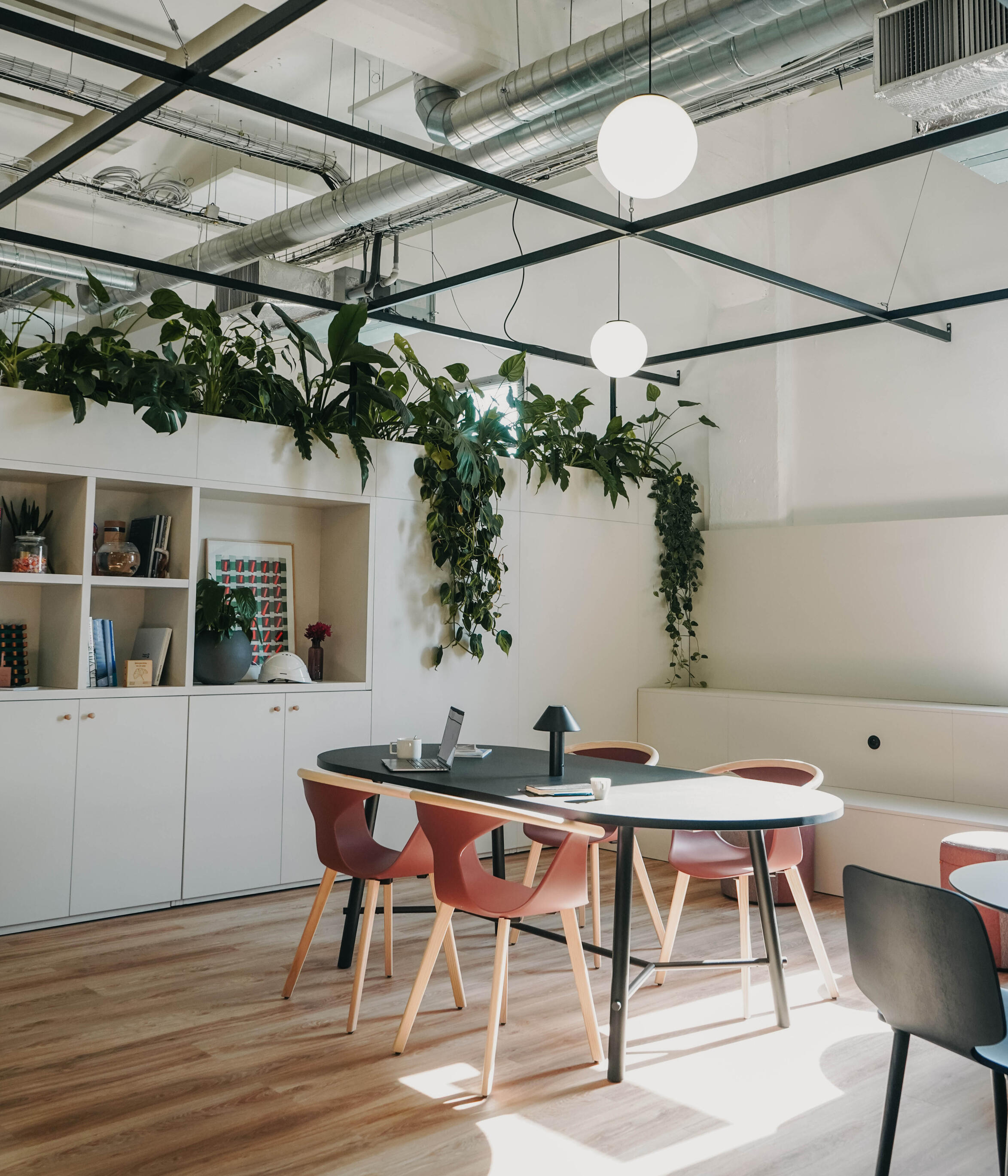 Creative workspace integrating industrial architecture, indoor plants and natural light.