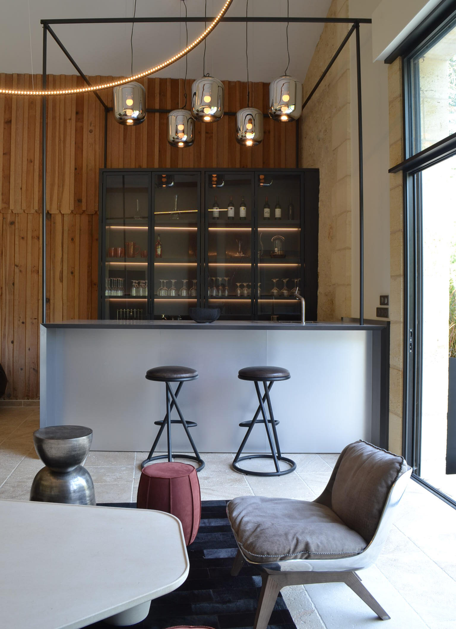Minimalist custom-designed bar integrating wood, metal and architectural craftsmanship.